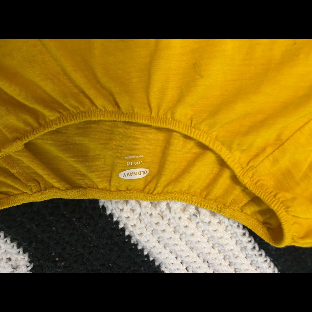 Gold long sleeve that flares out by the wrists.